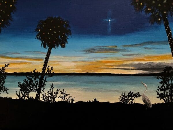 A heron graces the scene near a serene body of water at sunset, framed by the silhouette of palm trees and lush foliage, beneath a darkening sky where one bright star shines—just as beautifully depicted in Dove Christmas Cards.